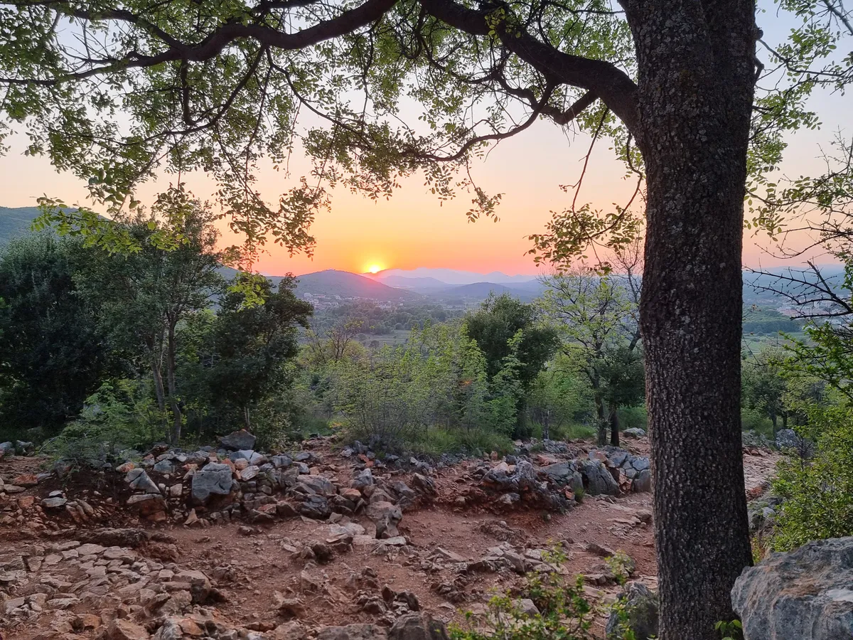 Sunset over the Herzegovina hills, seen from a stony path above the village